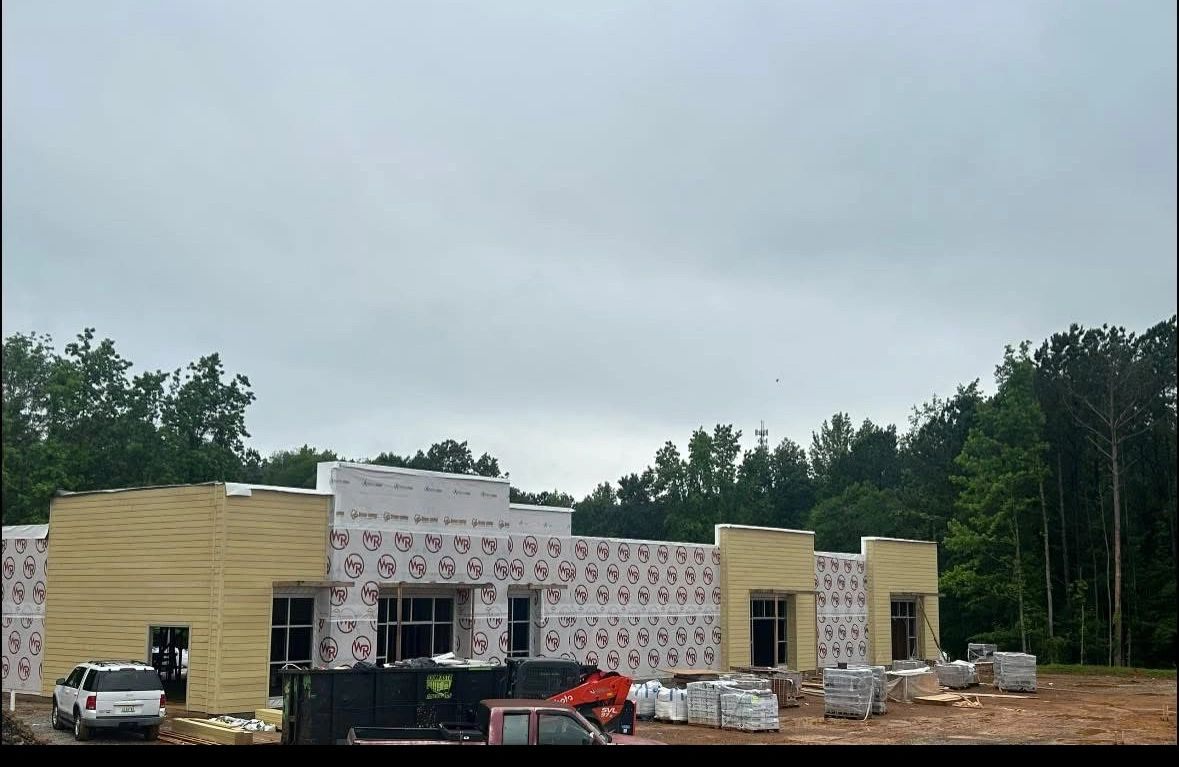 Convenience store under construction in Calera, Alabama — exterior framing and weather wrap