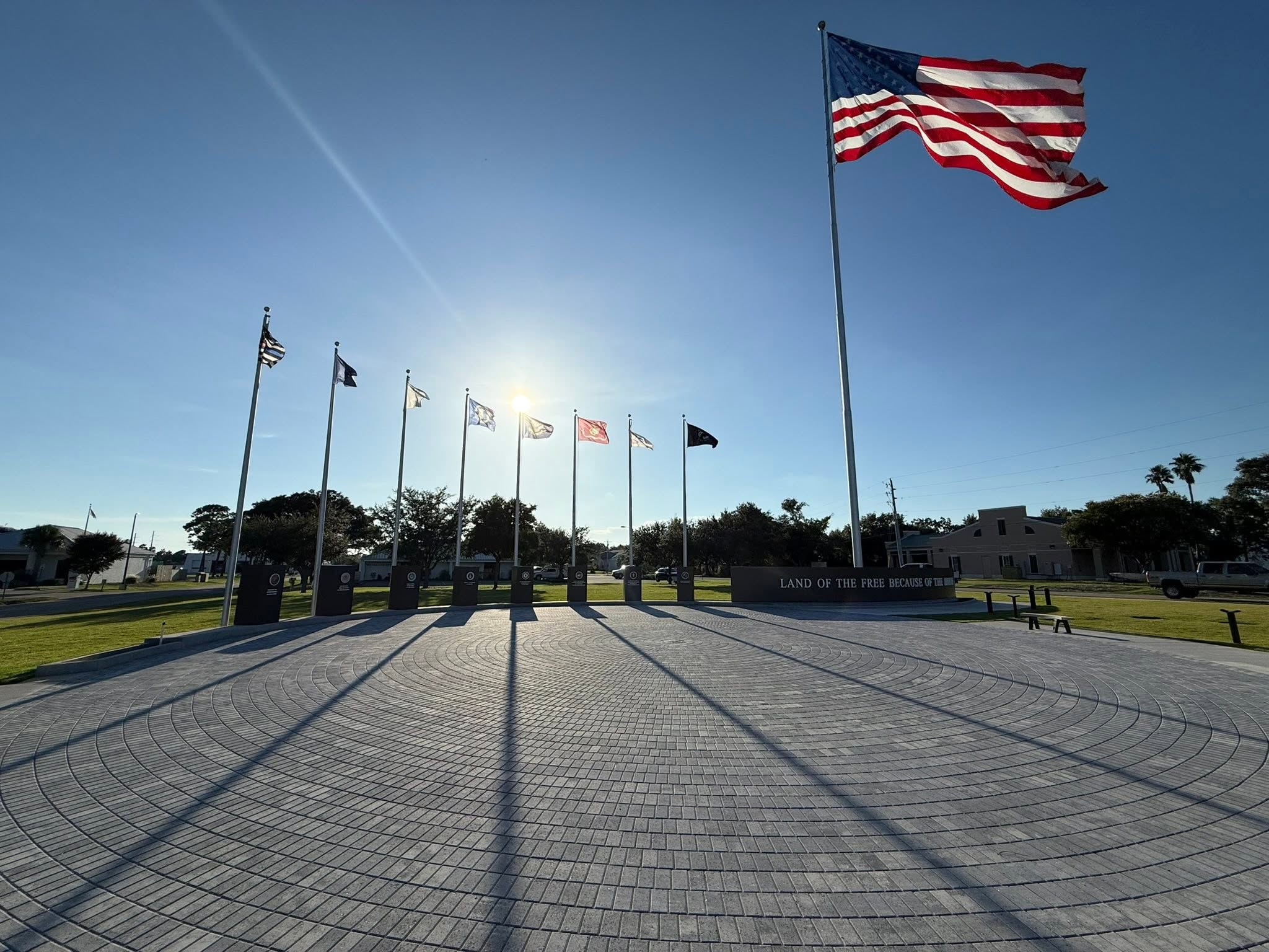 Completed veterans memorial in Orange Beach, Alabama — American flag on a 110-foot pole above the memorial plaza